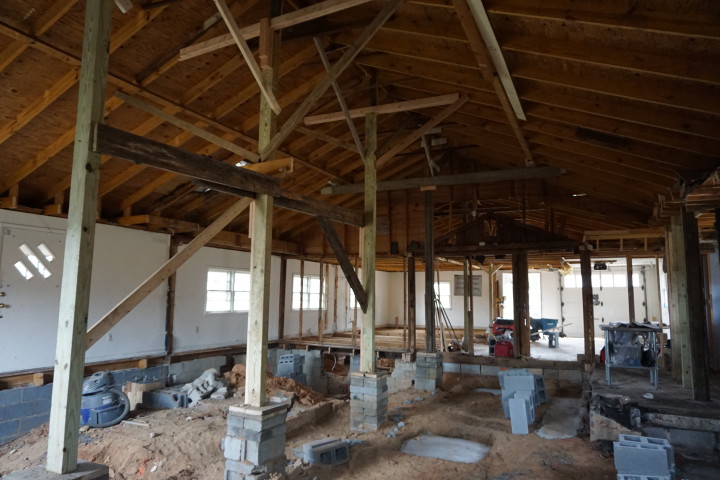 UP IN THE AIR: Although the building’s original floorplan and exterior are largely unaltered, the roof is being completely replaced and raised an additional 10 feet to create a lofted ceiling. Photo by Nick Wilson