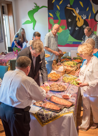 Guests at the 2016 Art in Bloom Gala preview party enjoy grilled salmon, a wide array of sides and farm-to-table veggies, craft brews and wine, before they study the floral arrangements paired with art in the Upper Gallery of the Arts Center. Photo courtesy of the Black Mountain Center for the Arts