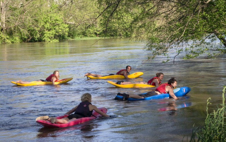 BELLY DOWN: Joining the Mountain Sports Festival event lineup this year will be a Prone Paddling sprint race in which competitors mount kayaks designed to be ridden face down and paddle with their hands. The Bellyak apparatus was invented by local kayak maker Adam Masters. Above, a group takes them out on the French Broad River for a casual float. Photo courtesy of Bellyak