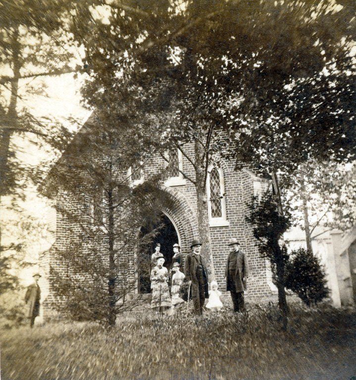 FIRST OF ITS KIND: Parishioners leave the first of Trinity's three churches in Asheville. It was built in 1849. Photo courtesy of North Carolina Collection, Pack Memorial Public Library, Asheville, North Carolina
