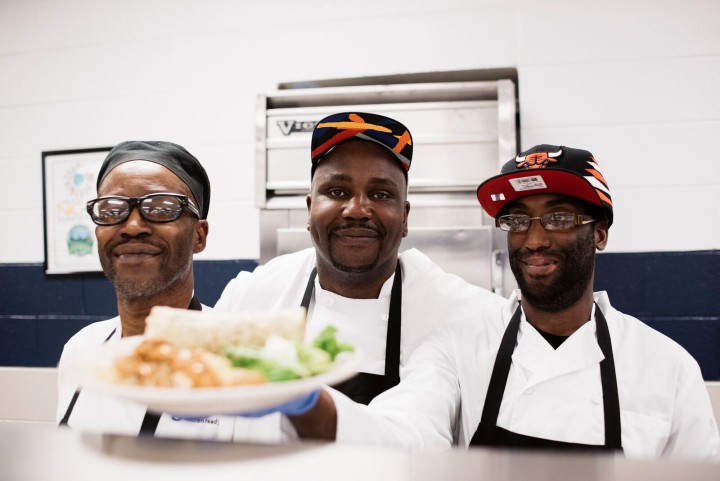 FULL PLATE: Providing delicious, healthy fare at each Homework Diner is the goal for GO Kitchen Ready chef instructor Gene Ettison, center. Also pictured are Guy Stivender, left, and Gary McDaniel, right. Photo by Jack Sorokin