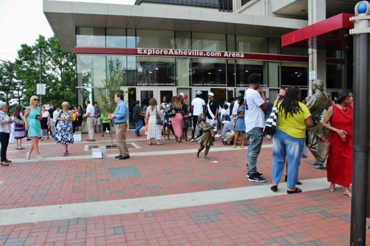 The plaza outside the U.S. Cellular Center fills and disperses quickly as anxious graduates and family members await graduation. Photo by Kari Barrows