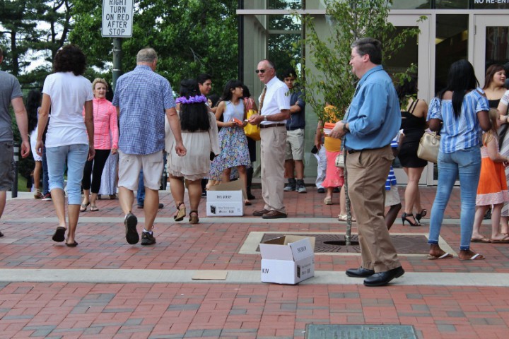Gideons dressed in collared shirts hand out Bibles to those who accept them. Photo by Kari Barrows