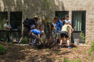 Landscaping Crew students plant a tree in honor of supervisor Tom La Muraglia, who is retiring after 20 years at Warren Wilson College. Photo by Reggie Tidwell