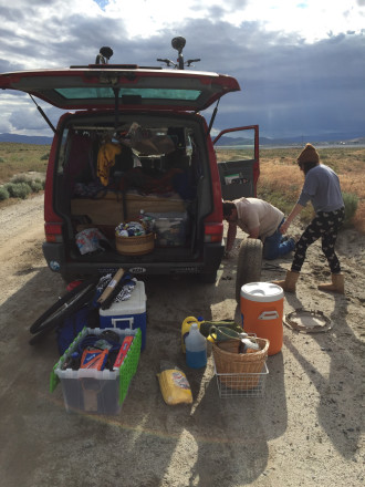 ON THE ROAD: Lovers of the van life follow their bliss, but they still have to attend to mundane tasks like changing a tire. Photo courtesy of the Gypsy Givers
