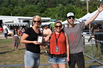 JUDGES' PICK: Gwendolyn Hageman, left, and Joshua Heald. right, of the Salvage Station accept their judges' choice award from WNC Battle of the Burger organizer Kelly Denson, center.  Photo by Jonathan Ammons