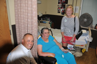 Nathan Waddell (left), director of sales for U.S. Cellular in Asheville, and Amelia Day (right), creator of Operation Veteran Smiles, share care package with Sherri McGahee, Navy veteran and resident at Charles George VA Medical Community Living Center. Photo courtesy of event organizers