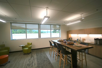 OFFICE SPACE: The interior of Explore Asheville's new office space, which was refurbished from a former girls' dormitory for Shaw University, features more private offices and cubicles for CVB staff, ample natural light, and several conference rooms, including a combination kitchen/meeting space. Photo by Max Hunt