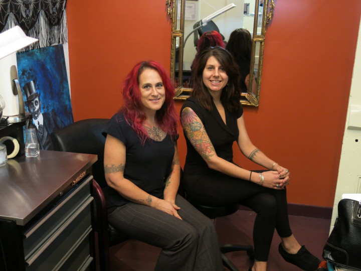 LEADING THE WAY: Kitty Love, left, has been tattooing in Asheville since 1996. She recently opened Sky People Tattoo with business partner Jenna Caristo. Photo by Thomas Calder 