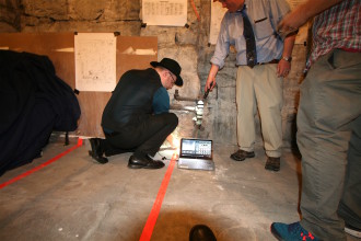SUBTERRANEAN SIGHTS: Warren, left, and AMT Board Vice President Christian MacLeod plumb the depths of a mysterious cavern below the basement floor of the Masonic Temple using a "snake cam." Photo by Max Hunt