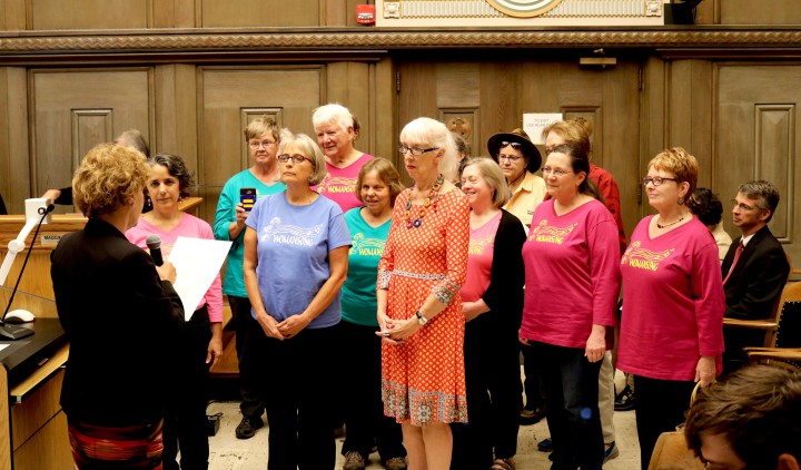 WOMANSONG DAY: Vice Mayor Gwen Wisler presents members of the Asheville women's chorus Womansong with a proclamation recognizing the group's contributions to the community since its founding in 1987. Photo by Carolyn Morrisroe