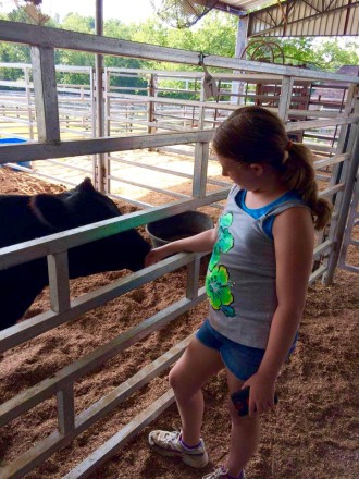 HEAD, HEART, HANDS AND HEALTH: Youths gain personal and professional development from their experience in 4-H, and make some furry friends along the way. Photo courtesy of Buncombe County 4-H