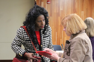 Dee Williams, right, speaks with a member of the audience after the forum. Photo by Virginia Daffron