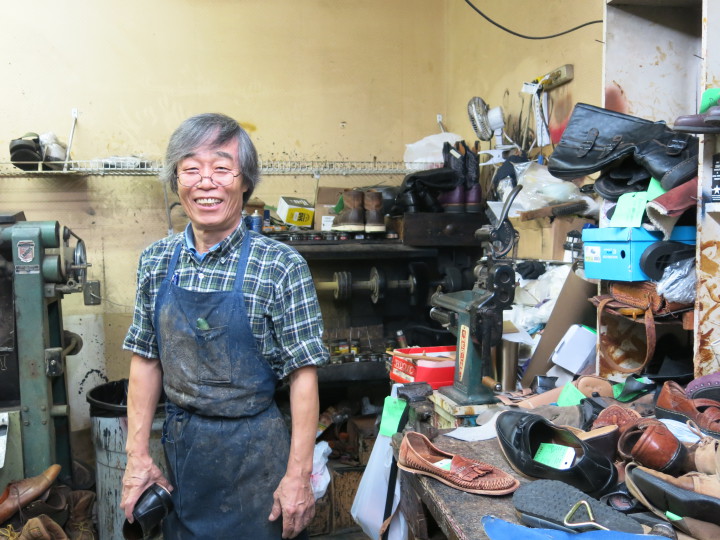 AS GOOD AS NEW: In Korea, Tong Kim worked as a shoemaker. Since arriving to Asheville in the '70s, he's turned his attention to shoe repair. Photo by Thomas Calder 