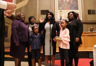 SOLEMNLY SWEAR: Sheneika Smith is sworn into office surrounded by her family. Photo by Carolyn Morrisroe