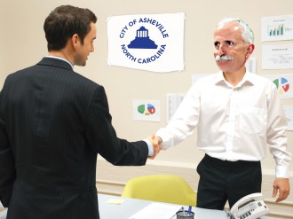 HEAVY-HANDED DEALS: City Manager Gary Jackson welcomes a representative of the SCAM consultancy firm to Asheville (and the city’s coffers). Photo via Flickr