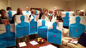 IN THE CROSSHAIRS: Attendees of a concealed carry class in Fletcher show off their targets following their concealed carry qualifications. Photo courtesy of Dan Meadows