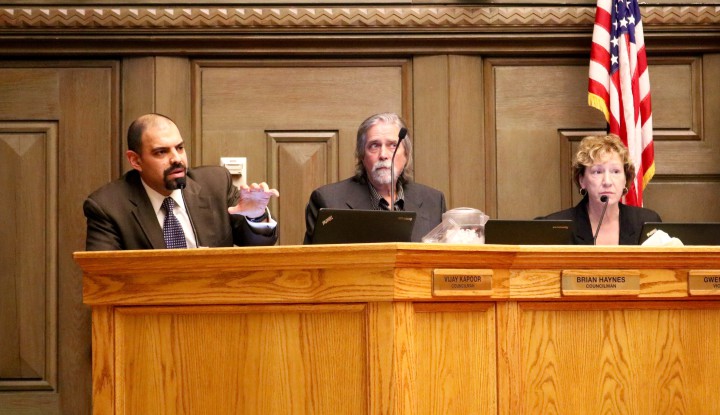 CASCADE OF CLARIFICATION: Council member Vijay Kapoor asks Chuck McGrady what he means when he says he  might be "forced" to take action on Asheville's water, while Brian Haynes and Gwen Wisler look to McGrady for answers. Photo by Carolyn Morrisroe