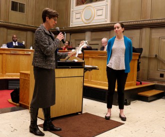 TEMPS, THEY ARE A-CHANGIN': Council member Julie Mayfield, left, presents The Collider’s Megan Robinson with a proclamation declaring March 19-25 to be “Asheville Climate Week” in advance of the ClimateCon event. Photo by Carolyn Morrisroe