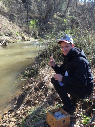 EQI AmeriCorps member Preston Welker collects a water sample at South Turkey Creek in Buncombe County.