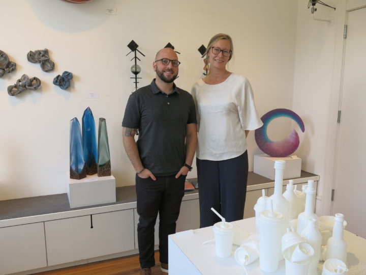 PAST AND PRESENT: Michael Manes, left, and Candace Reilly of Blue Spiral 1, note that the gallery's latest exhibit, Glass Takeover, is both a nod to the medium's history and an acknowledgment of the region's current talent. The exhibit runs through Friday, Oct. 26. Photo by Thomas Calder