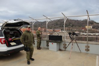 Officers with sniper rifle on Buncombe County parking deck