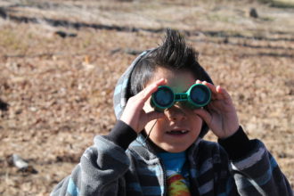 Young boy with binoculars