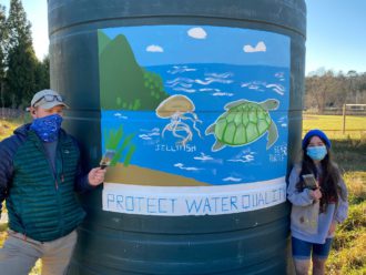 Isabella Conway and Michael Huffman with water conservation mural