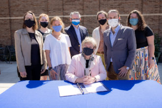 Nancy Cable signing UNCA carbon commitment