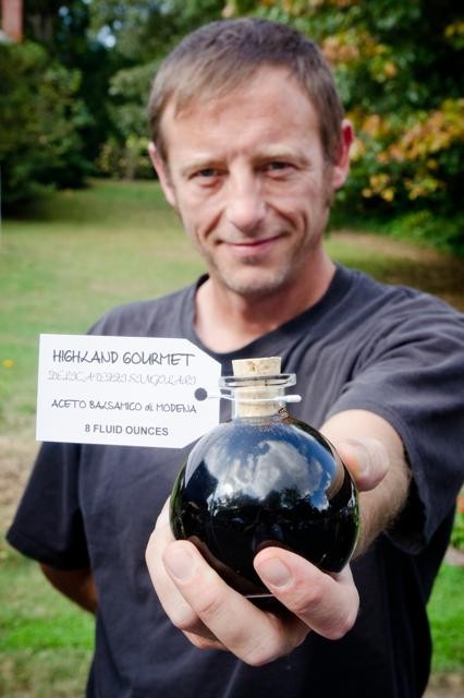 BOTTLED UP: Scott Waldrop sells his artisan balsamic vinegar in refillable, corked bottles. - 101613_11_11003mc