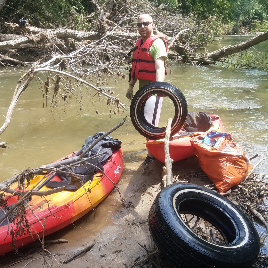 Lincoln Hamer with trash during Swannanoa River cleanup