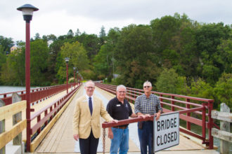 Executive Director of Lake Junaluska Ken Howle, Director of Lake Junaluska Public Works Jack Carlisle and Owner of RCF Construction Mackie McKay stand on the newly completed bridge.
