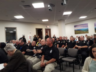 Buncombe County Sheriff's Office employees at a Board of Commissioners meeting