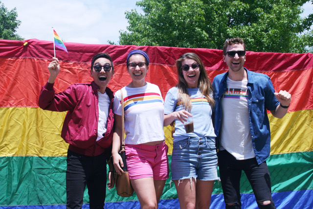 Attendees in front of rainbow flag at Hendersonville Pride Day