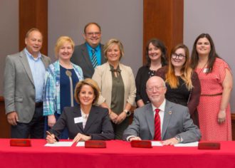 Laura Leatherwood and Ben Leslie sign an agreement between Blue Ridge Community College and Gardner-Webb University