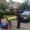 Police pulling over child in toy car