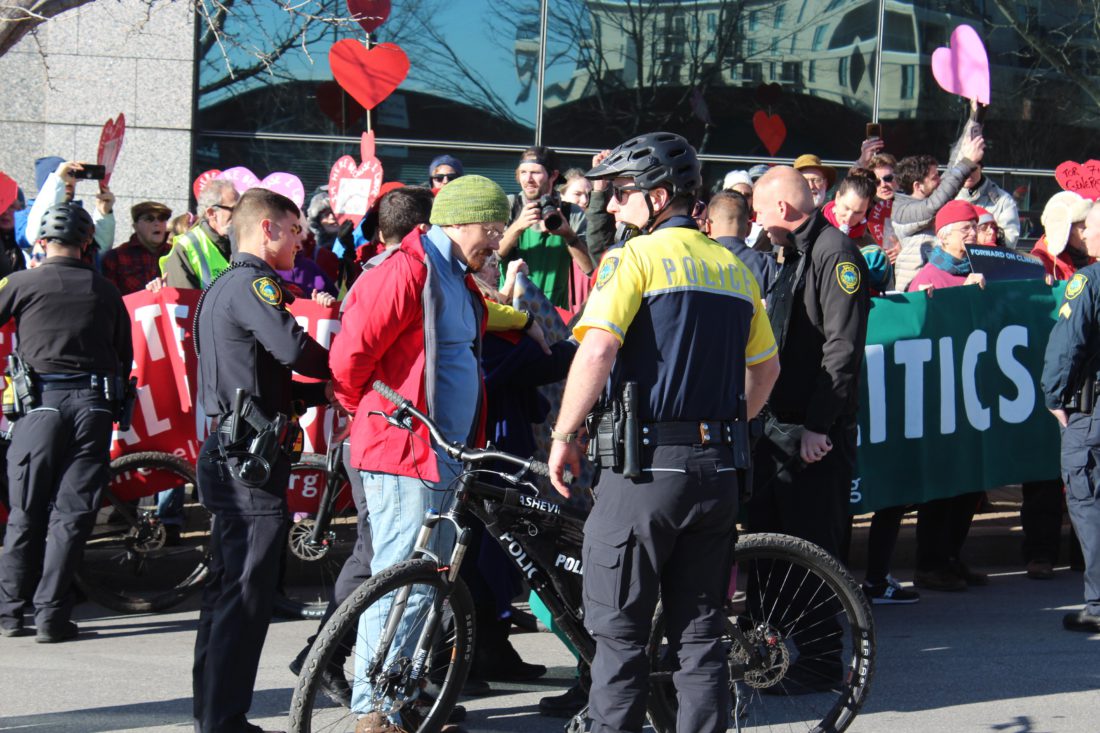 Extinction Rebellion protester being arrested by Asheville Police Department