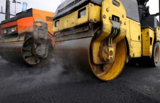 Steamrollers resurfacing a road