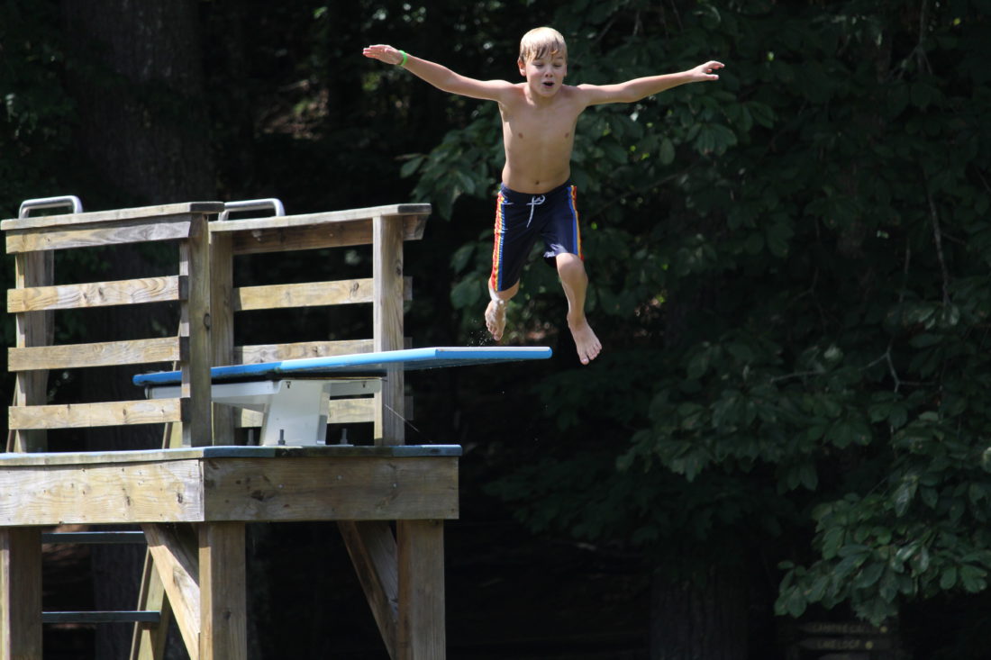 Child jumping off diving board at Camp Tekoa