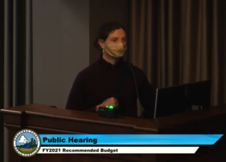 Masked commenter during June 16 Buncombe County public hearing