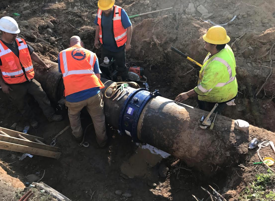 Asheville workers repair a water line at Bee Tree Creek