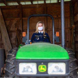 Enka High student on tractor