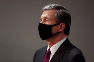 Roy Cooper in black facemask