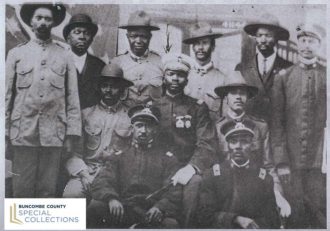 An historic photo of a group of Black men in various uniforms from Buncombe County
