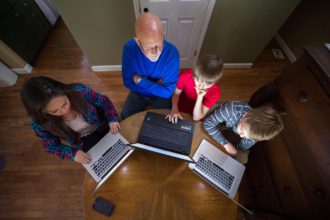 Family around laptops