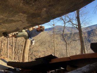 Rock climber at the Chimney Rock Village Boulders