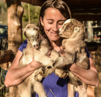 Megan Naylor with goat kids